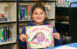 Girl holding up A Sofia Special book