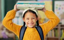 Child balancing books on head