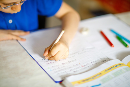 Child writing on notebook