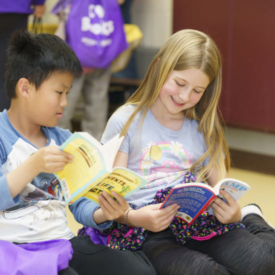 A boy and a girl reading together