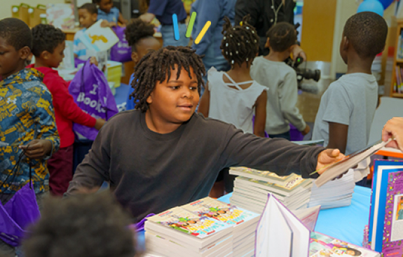 Boy choosing a book at event