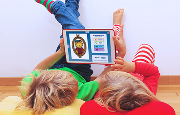Two kids reading with Skybrary on a tablet
