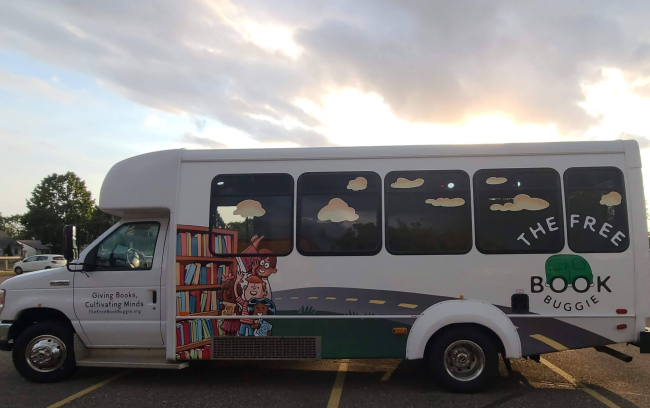 The Free Book Buggie, a bus with a design of a bookshelf along a road