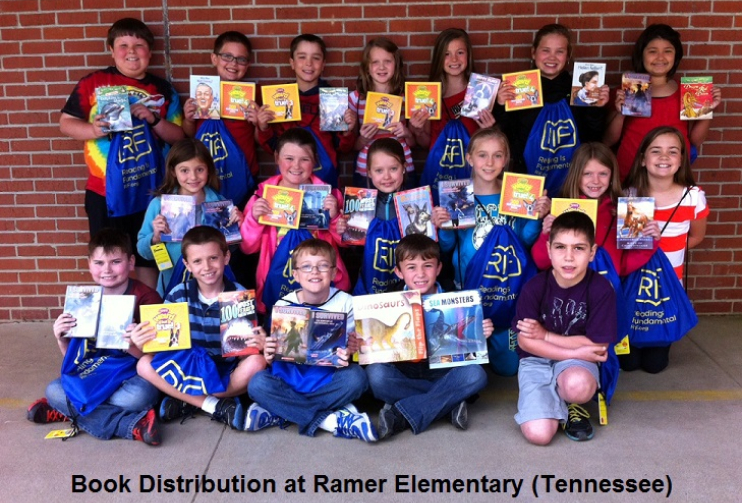 Children participating in the original IAL grant show off the books they selected for ownership at Ramer Elementary in TN.