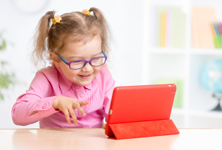 Girl reading digital resources and smiling with iPad 